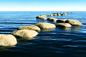 Path of stones on the ocean representing Investment Management